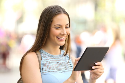 Business woman looking at accounting software on tablet